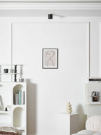 Modupoint ceiling light shown lit in a warm white tone in a styled interior