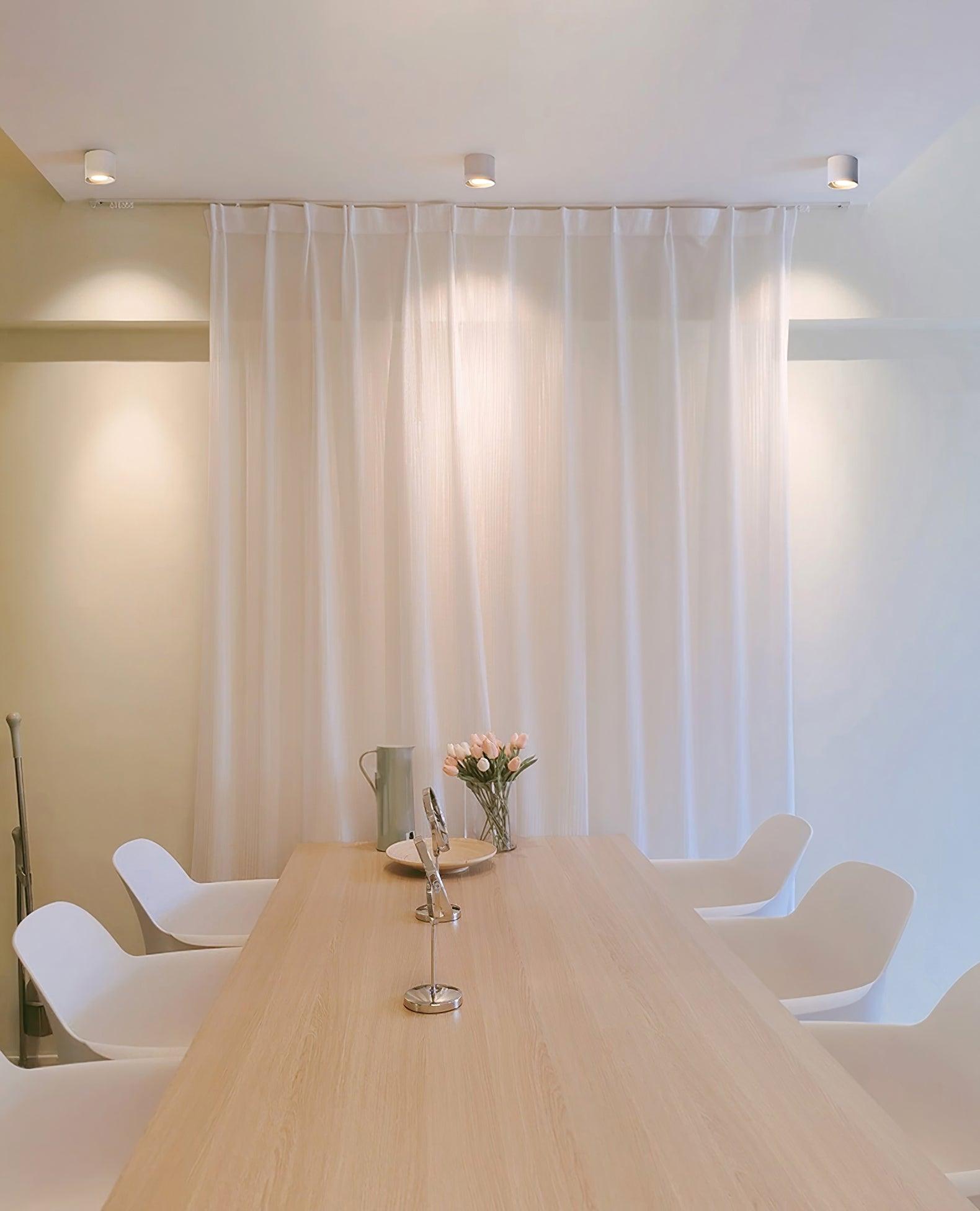 Modupoint ceiling light in white casting an even, low-glare pool of light