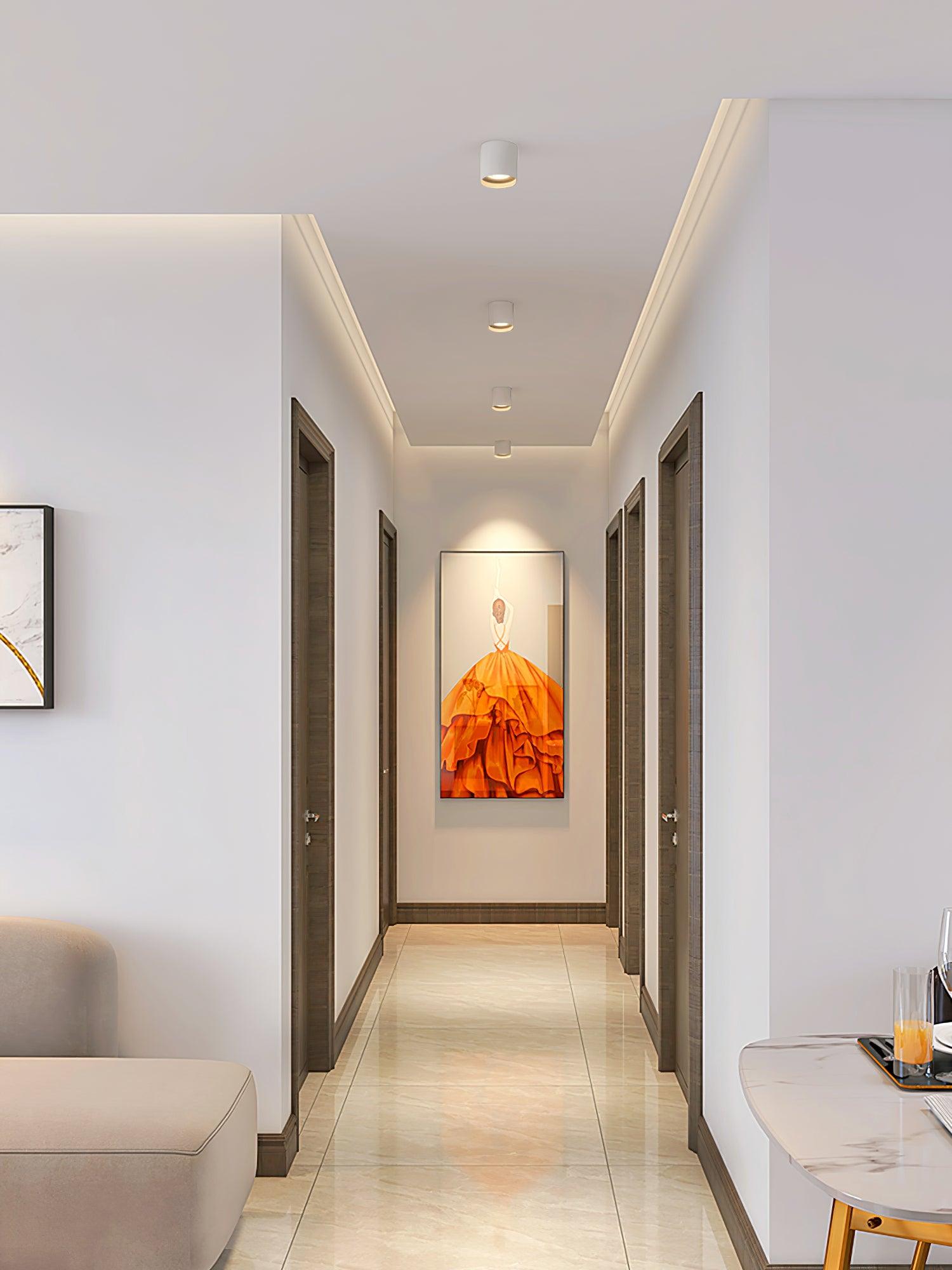 Modupoint ceiling light shown lit in a warm white tone in a styled interior