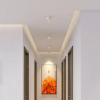 Modupoint ceiling light shown lit in a warm white tone in a styled interior