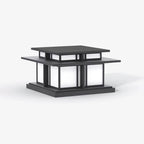 Unlit, this Clérachic pillar light sits on a plain grey backdrop, showing its dark frame and frosted glass panels.