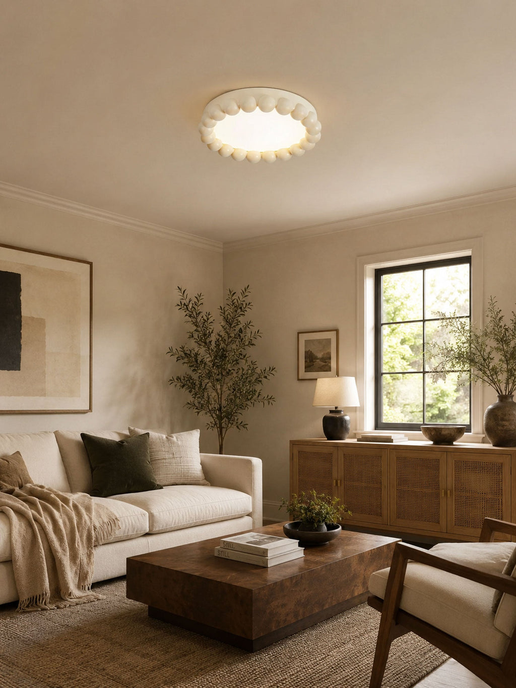 This Clérachic ceiling light in white sits flush on the ceiling of a beige living room with a linen sofa and wood console.