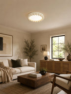 This Clérachic ceiling light in white sits flush on the ceiling of a beige living room with a linen sofa and wood console.