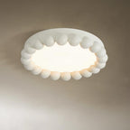 Close view of this Clérachic ceiling light in white, its beaded ring and glowing diffuser shown against a taupe backdrop.