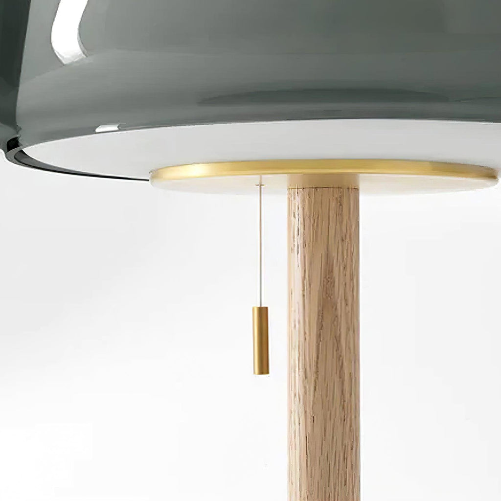 Close-up looking up at the underside of the Clérachic lamp's smoked-grey glass shade and brass collar.