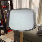 Close-up from below of the Clérachic lamp's glass shade, showing its frosted white glow through smoked glass.