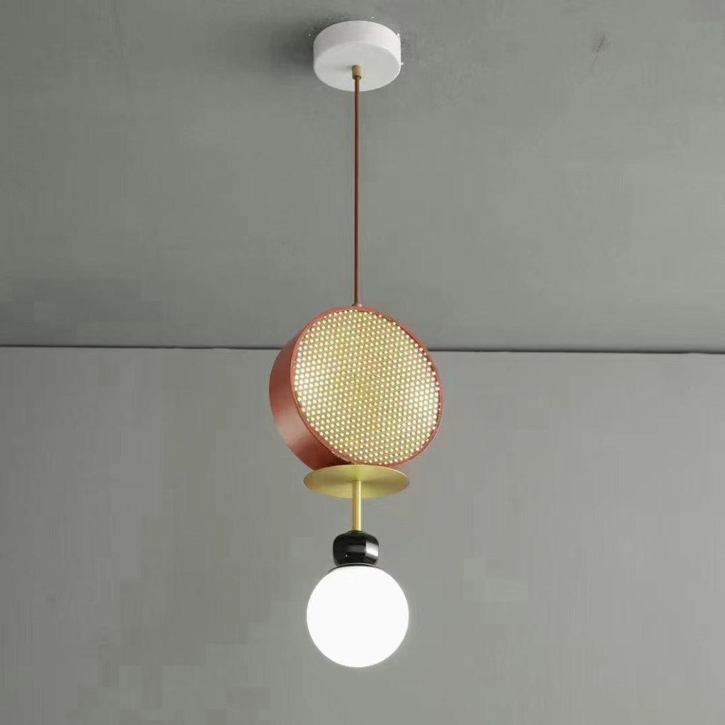 Small single-arm Clérachic pendant with a copper cane drum and opal glass globe, hanging against a plain grey wall.