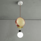 Small single-arm Clérachic pendant with a copper cane drum and opal glass globe, hanging against a plain grey wall.