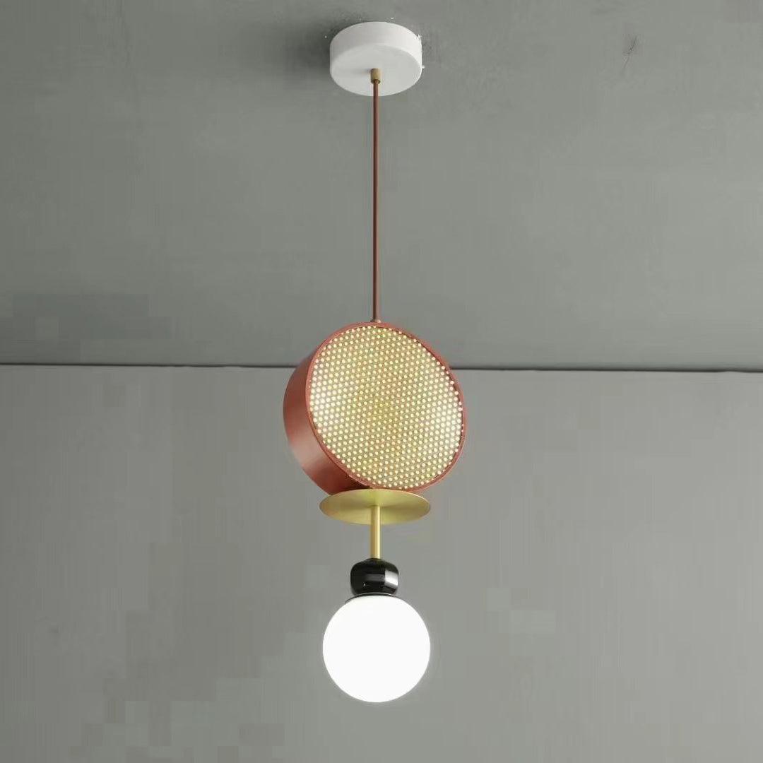 Small single-arm Clérachic pendant with a copper cane drum and opal glass globe, hanging against a plain grey wall.