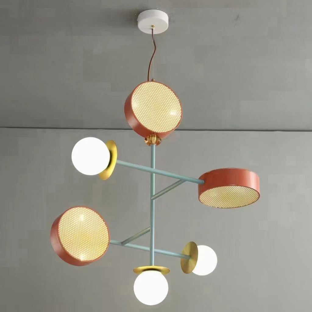 Larger Clérachic chandelier with a teal cross-rod, several cane drums and glass globes, hanging from a plain grey ceiling.