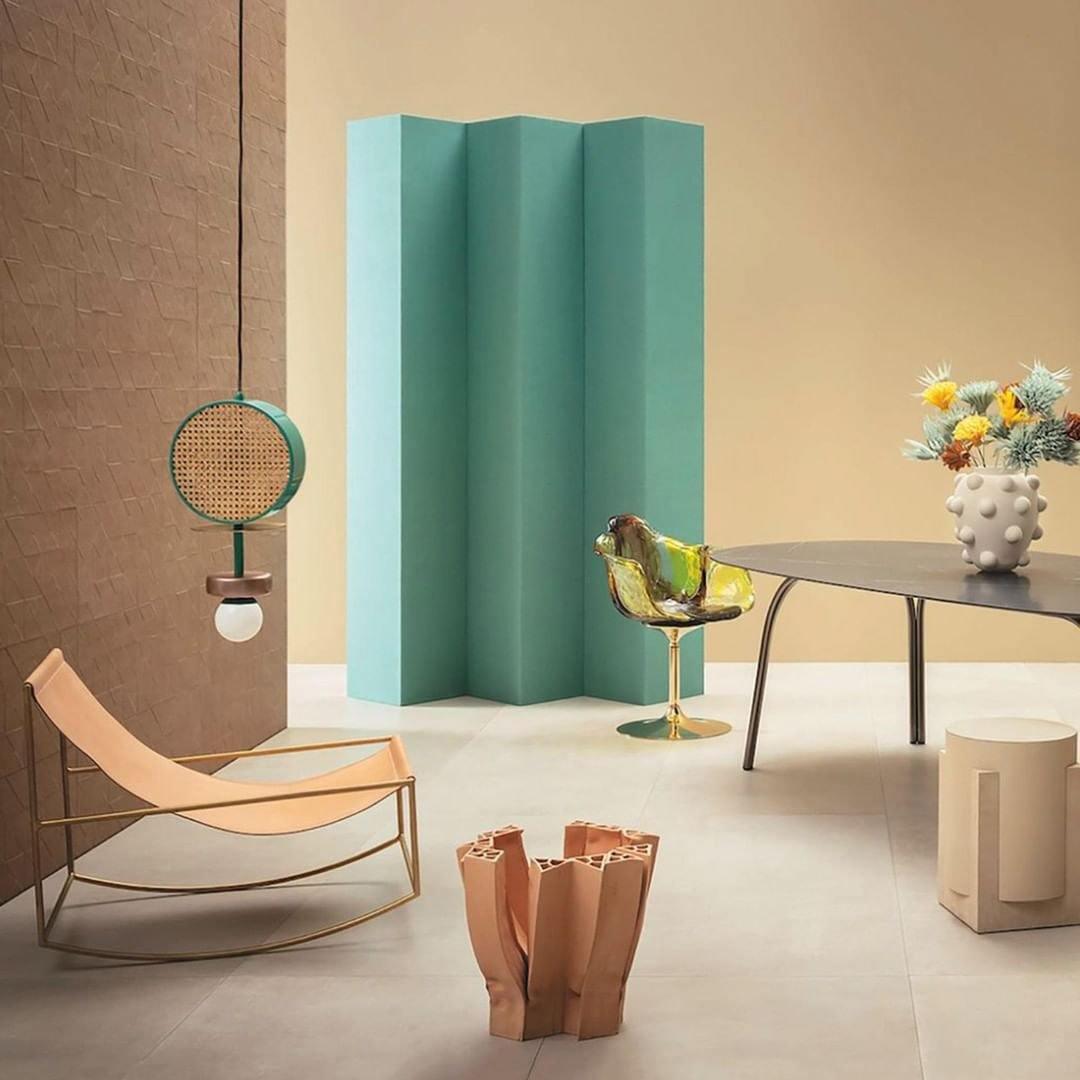 Small Clérachic drum pendant hanging beside a teal folding screen in a warm, tan-toned sitting room.