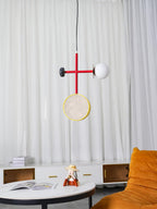 A third crop of the Clérachic pendant above the round table, sheer curtain and orange chair, taken from a slightly lower angle.