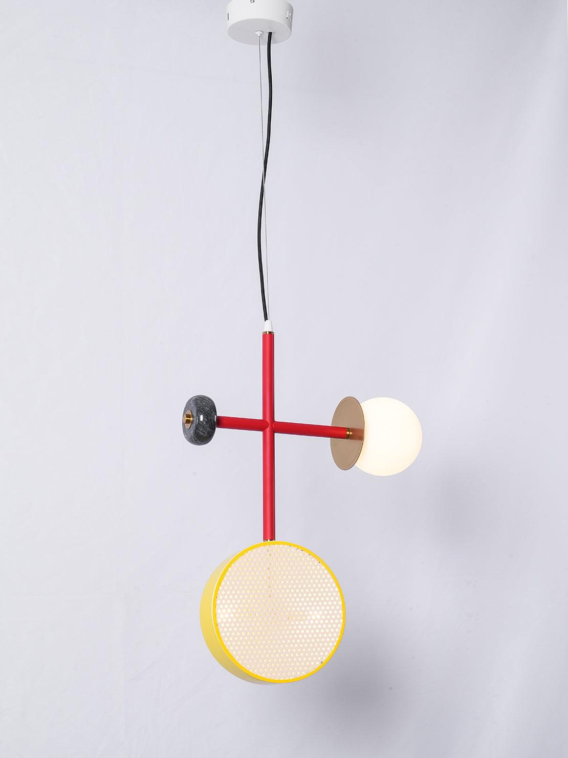 Clérachic pendant with a red cross-rod, dark bead end cap, yellow-rimmed cane drum and opal glass globe, hung from a white ceiling plate.
