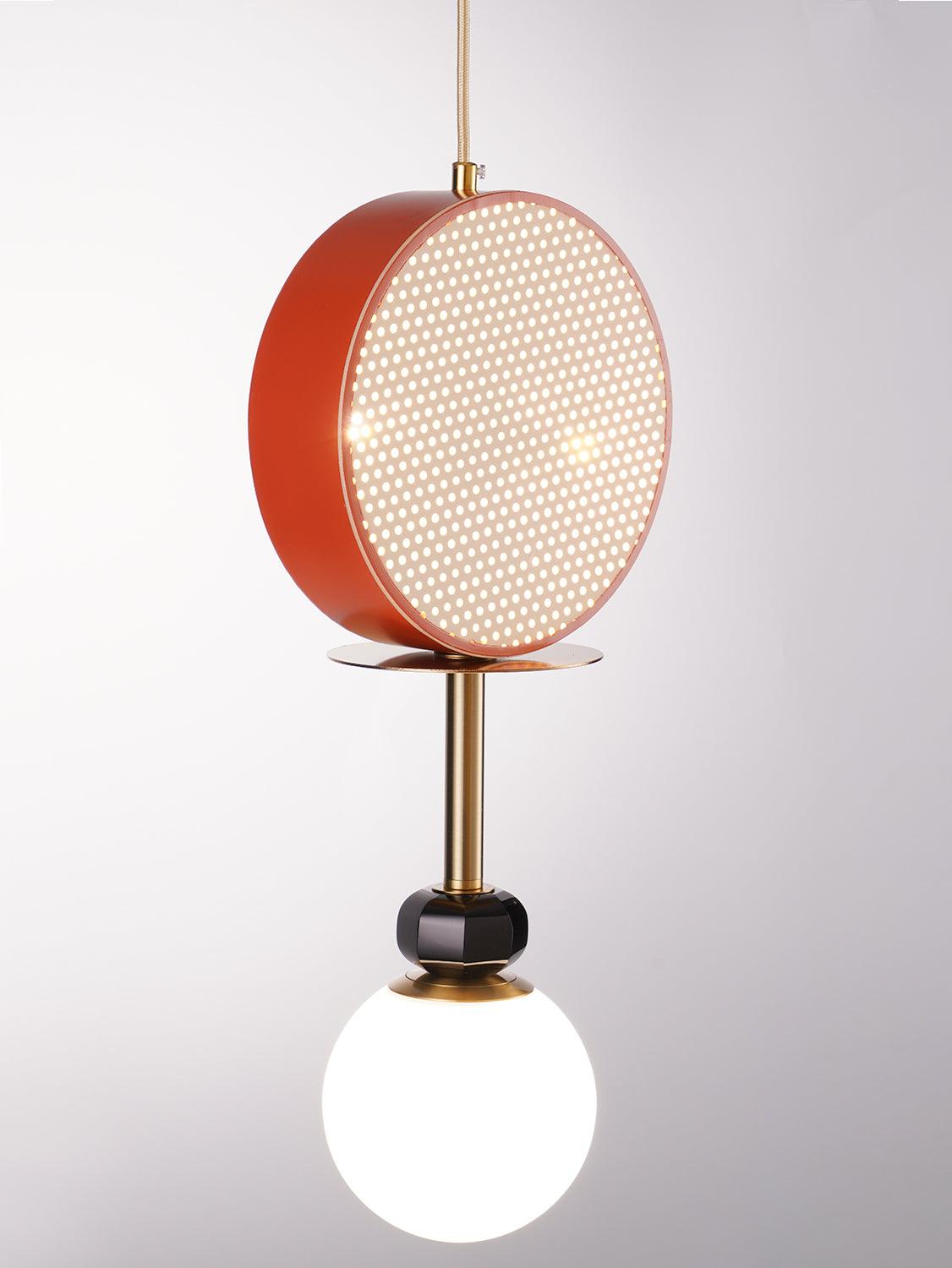 Close crop of the Clérachic pendant's terracotta cane drum shade, its rattan weave lit from behind, against a white wall.