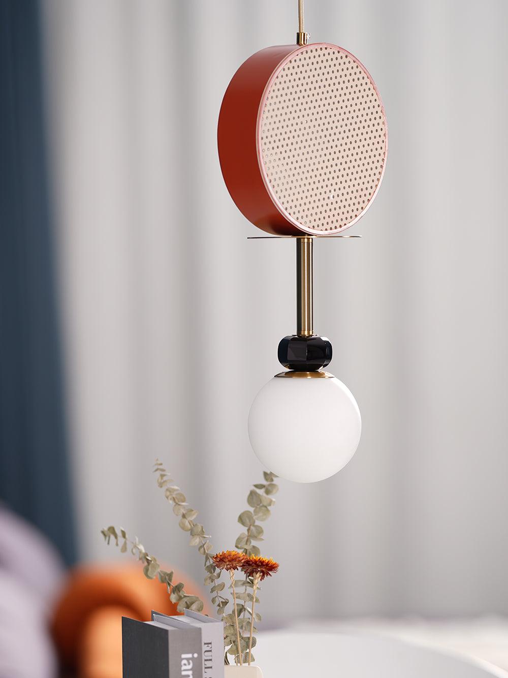 A closer crop of the same Clérachic pendant against the teal curtain, its cane drum shade filling more of the frame.