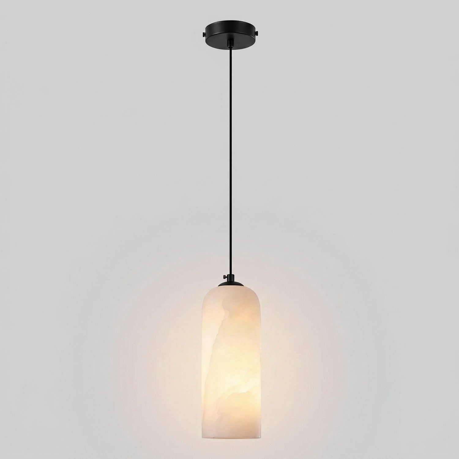 Monty alabaster pendant glowing warm through the natural stone shade