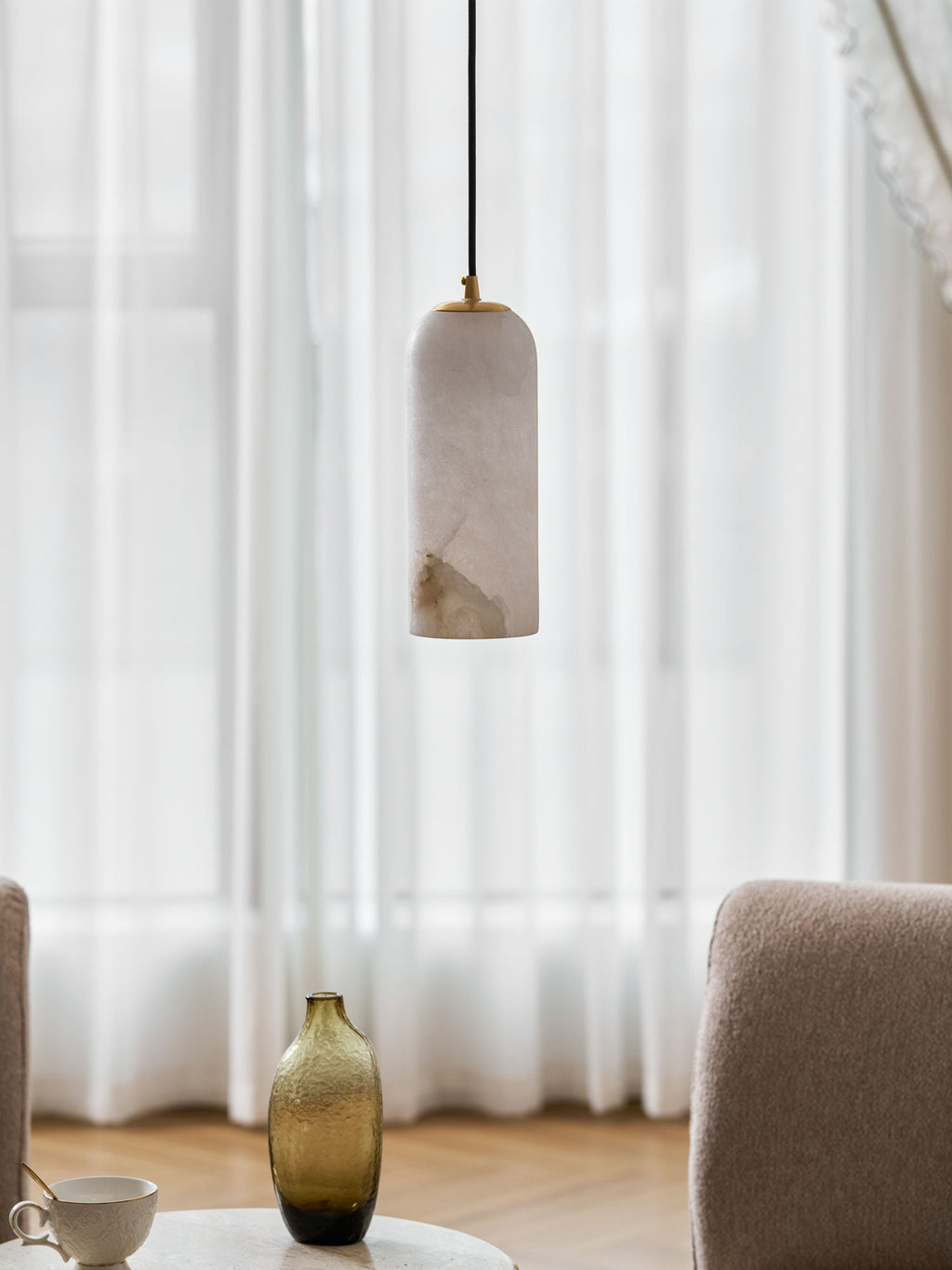 Monty alabaster pendant styled in a warm foyer