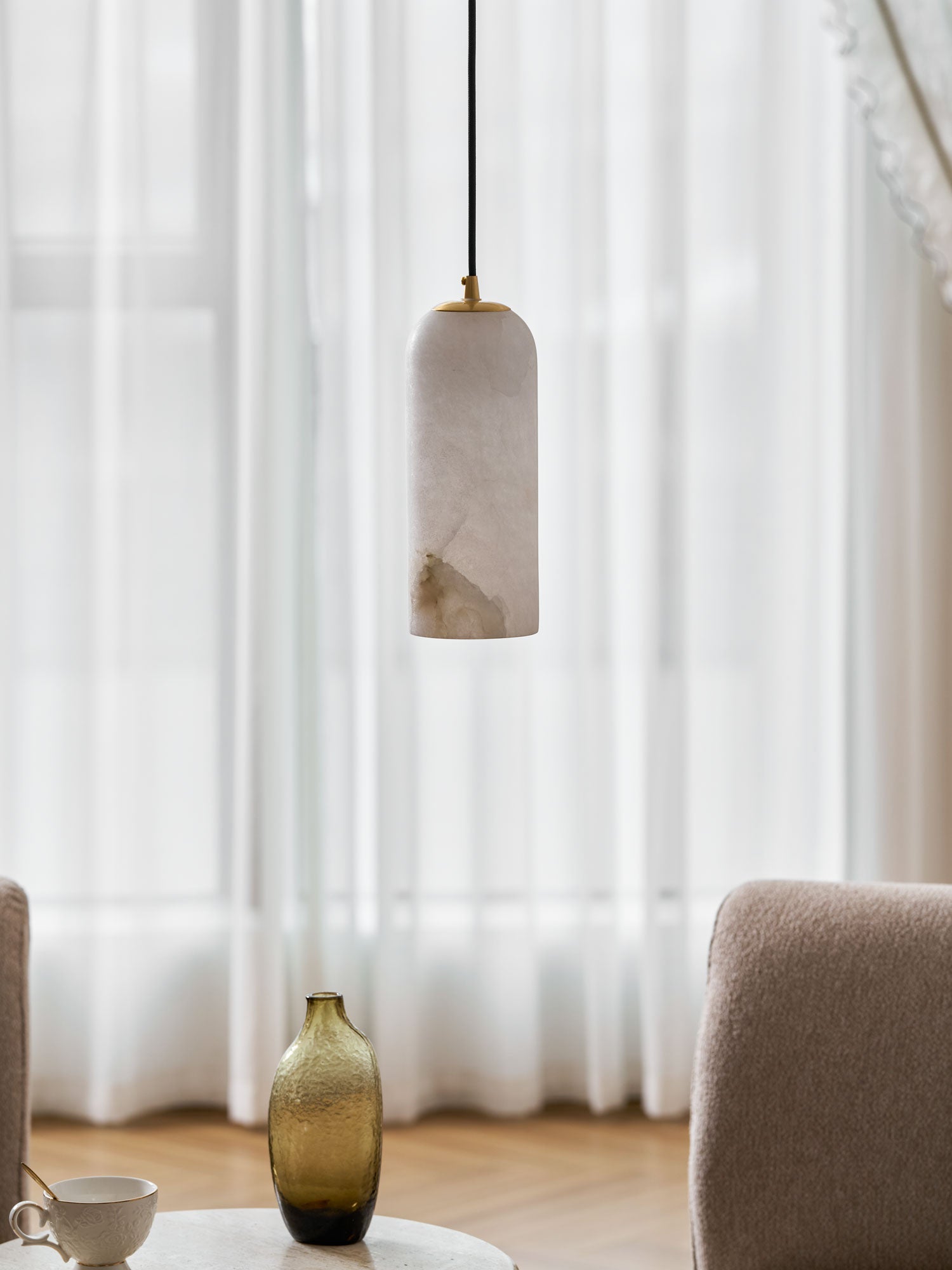 Monty alabaster pendant styled in a warm foyer