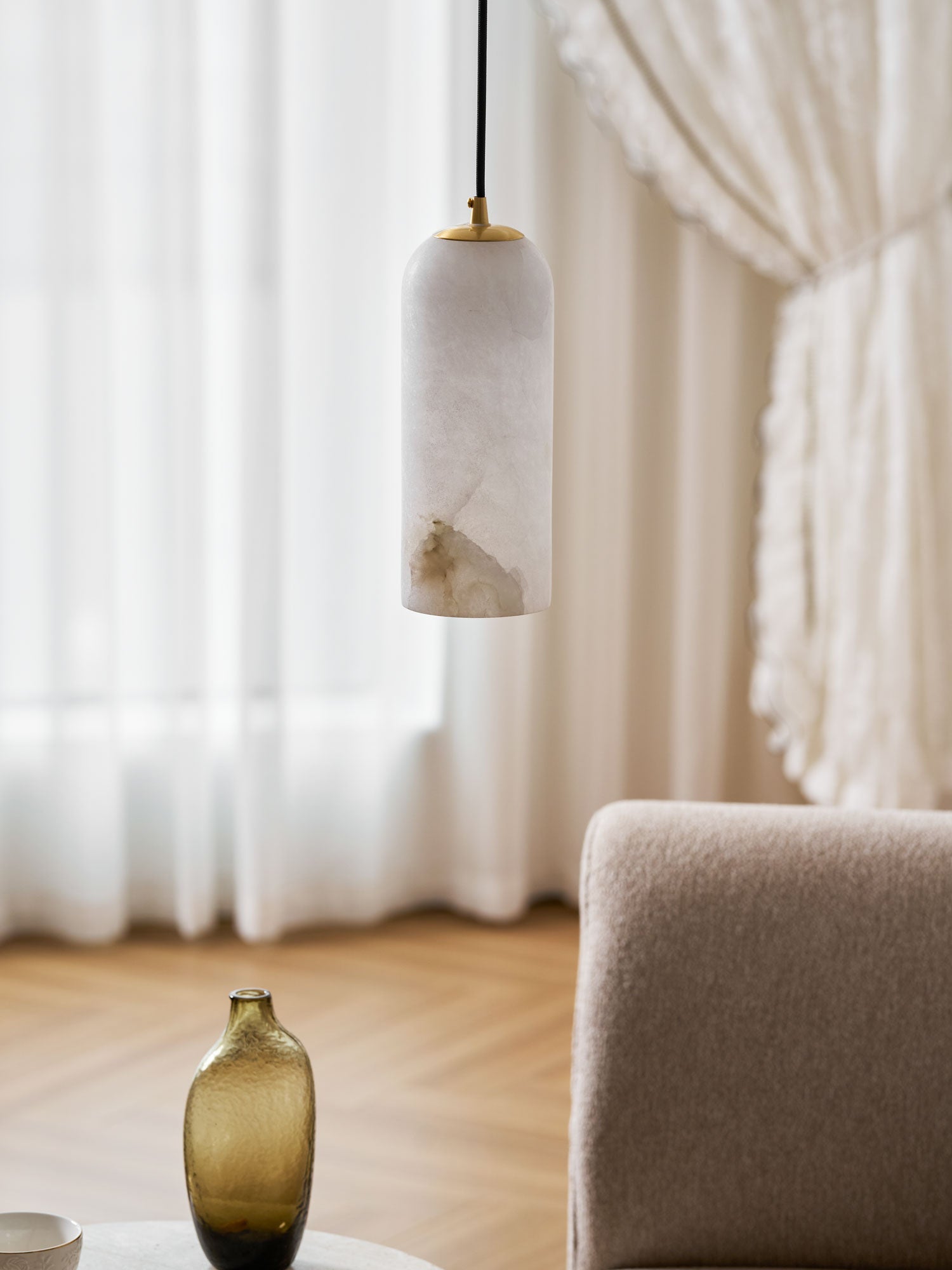 Monty alabaster pendant styled over a dining table