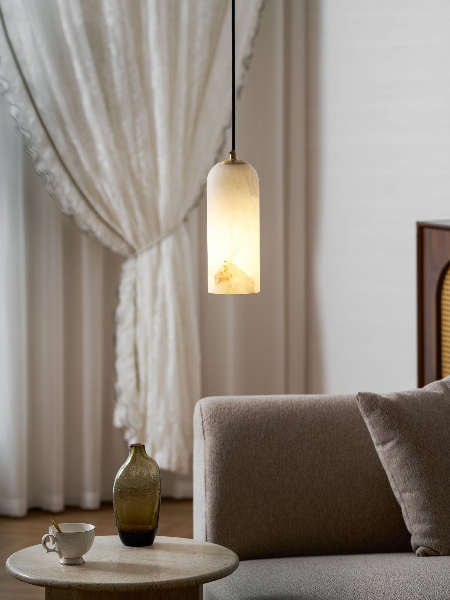 Monty alabaster pendant cluster lit in a warm interior