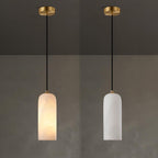 Two Hecate pendants on brass ceiling plates compared side by side: one lit warm, one unlit cool white.