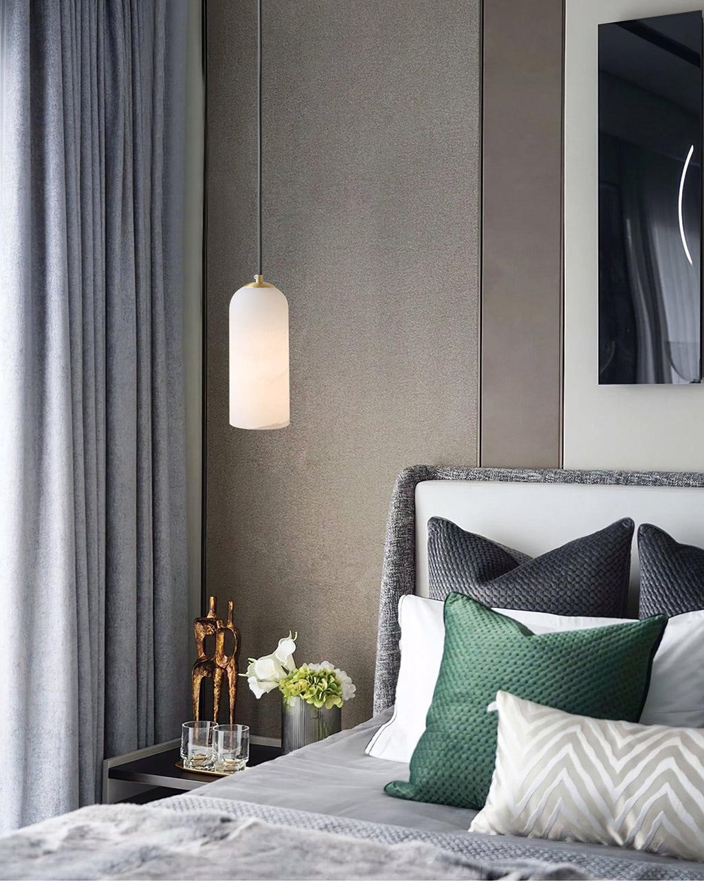 Zashayra pendant used as a bedside light in a grey bedroom with green and charcoal cushions.