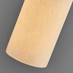 Close-up crop of the lit alabaster shade, showing the stone's mottled grain against a grey backdrop.