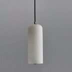 The Zashayra pendant unlit against a grey wall, the shade a cool white with faint grey veining.