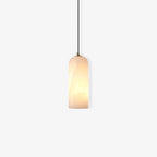 Studio shot of the Zashayra pendant lit from within, the bulb revealing the alabaster's cloudy veining.