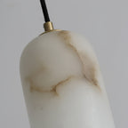 Close-up of the alabaster shade's brass collar and fabric cord, with the stone's brown veining