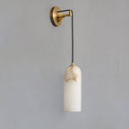 Vaelara alabaster wall sconce switched off, showing the cream stone shade's natural brown veining