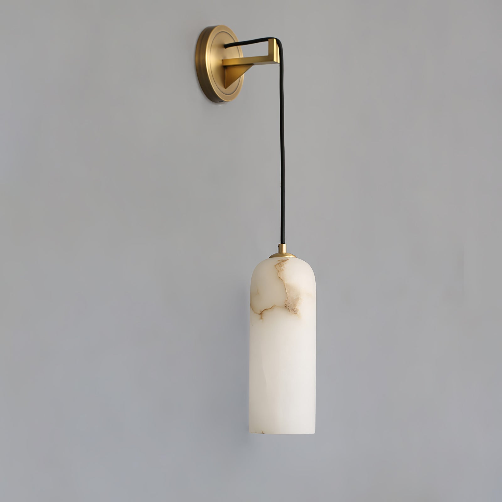 Vaelara alabaster wall sconce switched off, showing the cream stone shade's natural brown veining