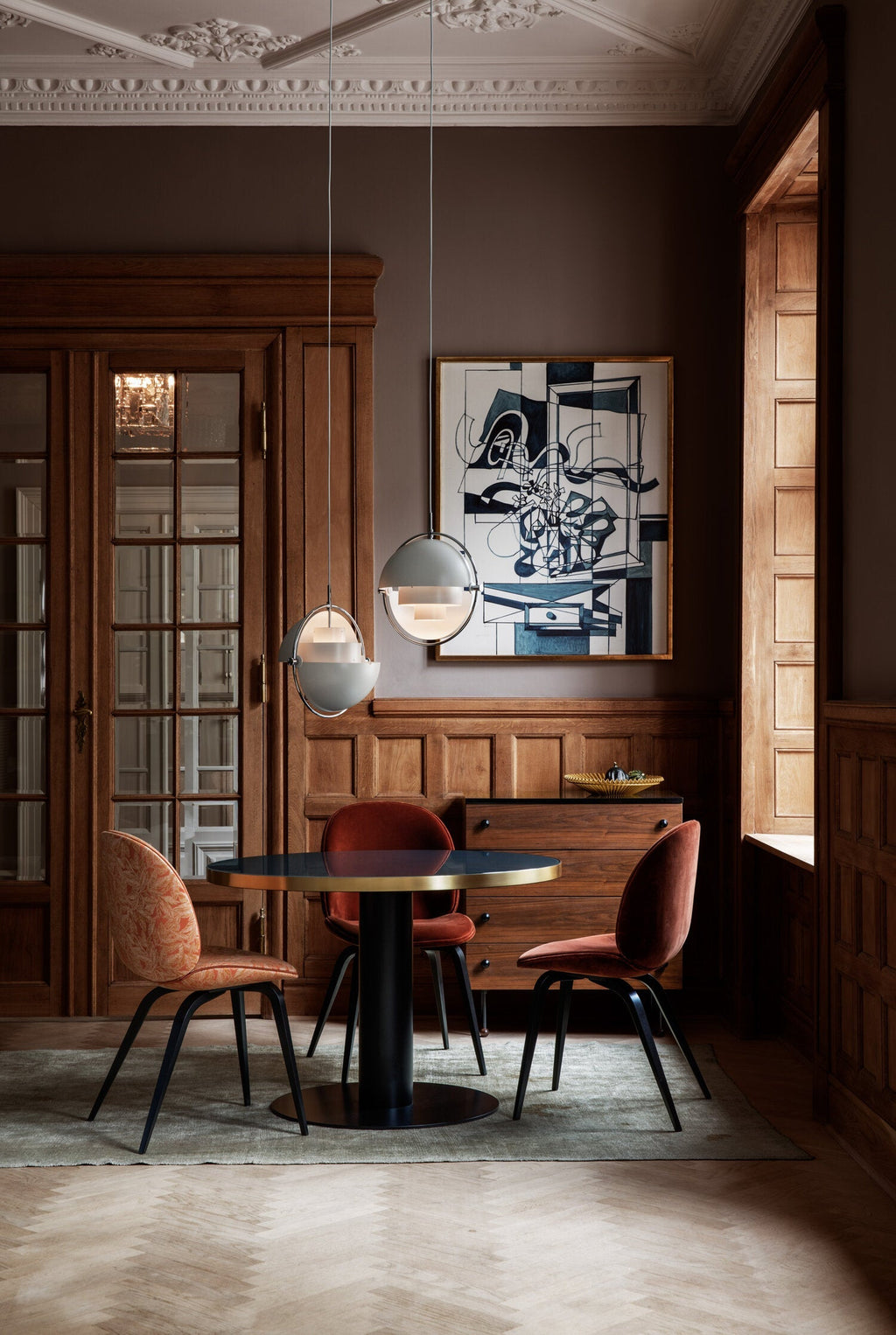 Multi-Lite pendant light over a dining table casting a focused downward pool of light
