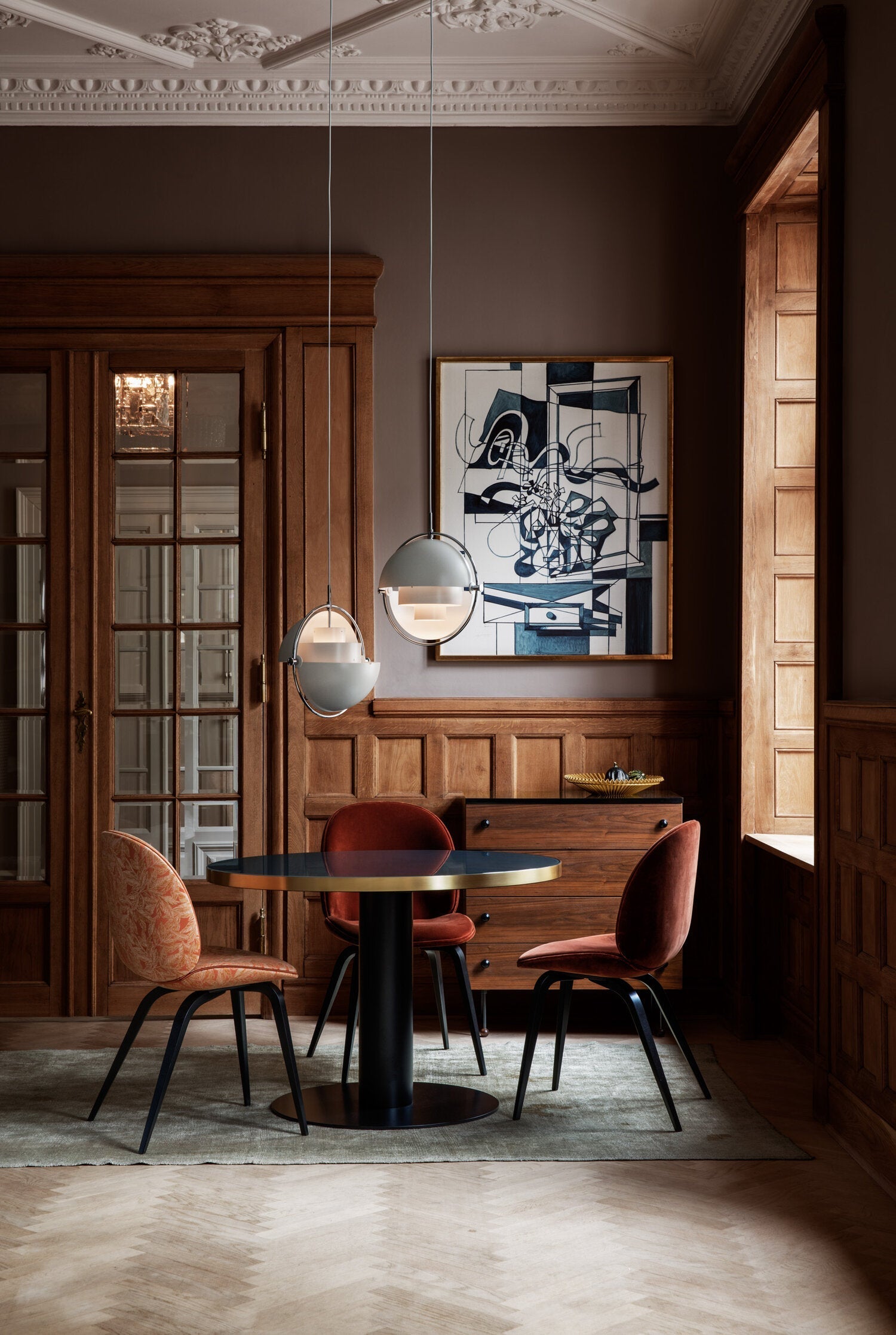 Multi-Lite pendant light over a dining table casting a focused downward pool of light