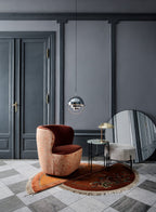 Multi-Lite pendant light with two movable hemisphere halves hanging in a styled interior
