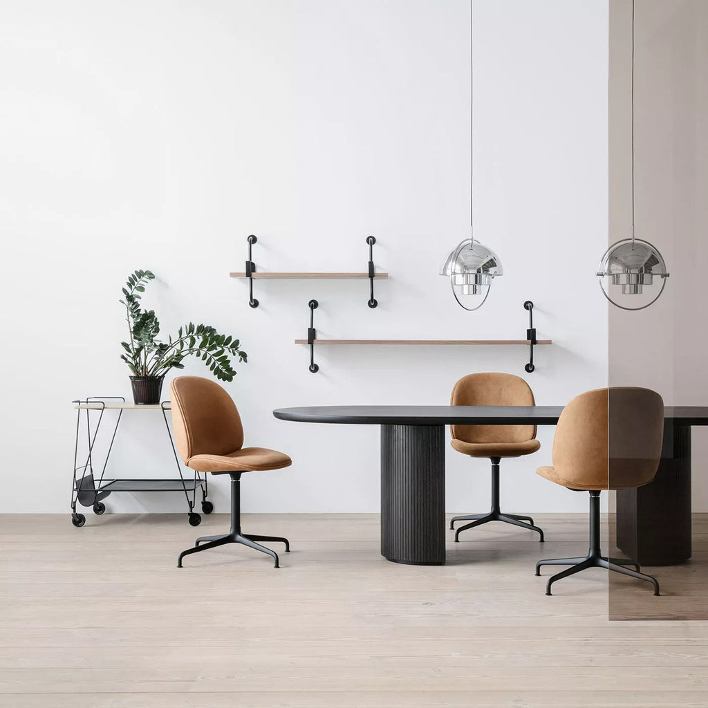Multi-Lite pendant light over a dining table casting a focused downward pool of light