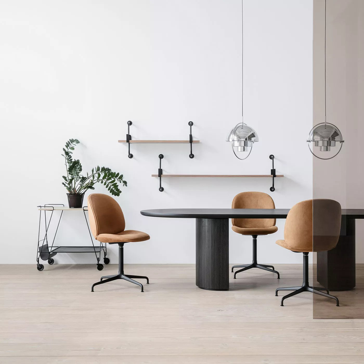 Multi-Lite pendant light over a dining table casting a focused downward pool of light