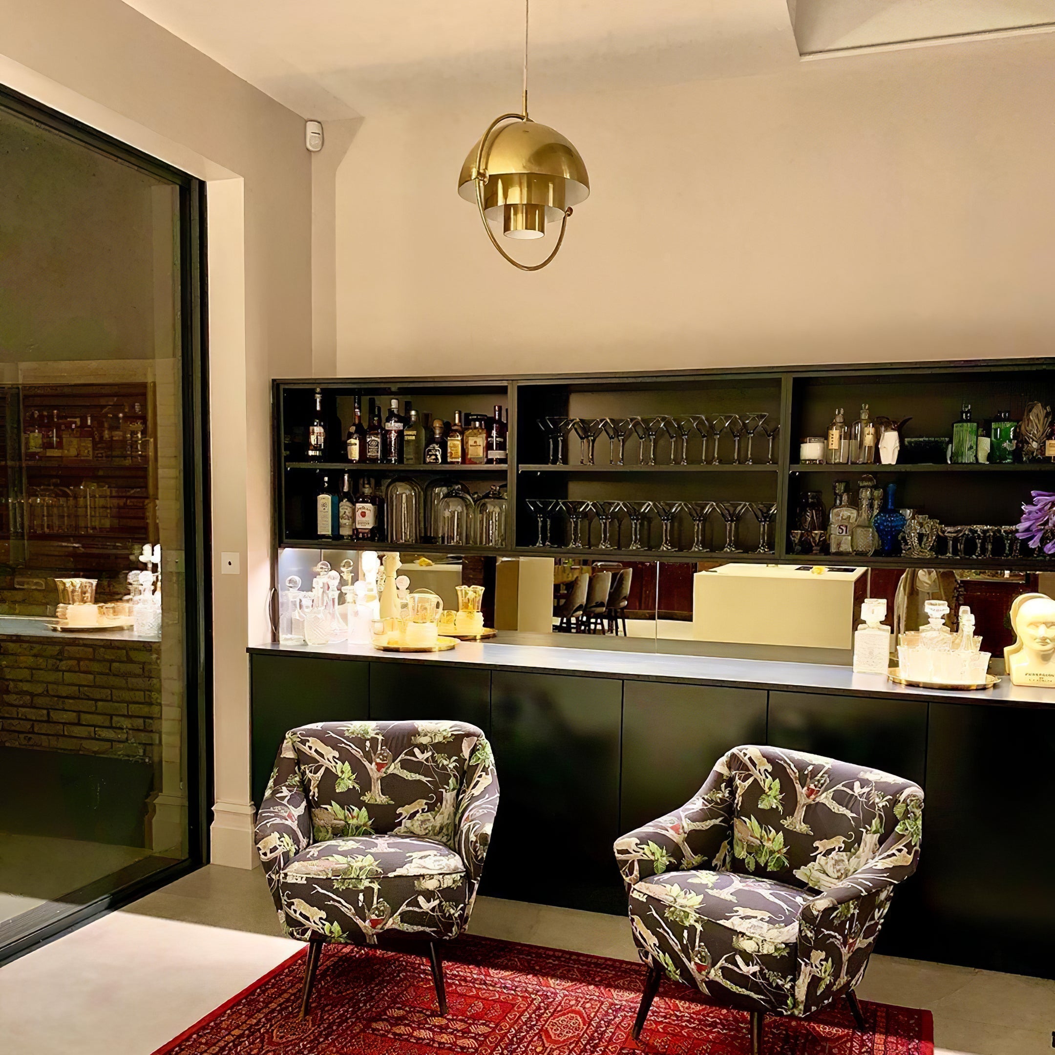 Multi-Lite pendant light with two movable hemisphere halves hanging in a styled interior