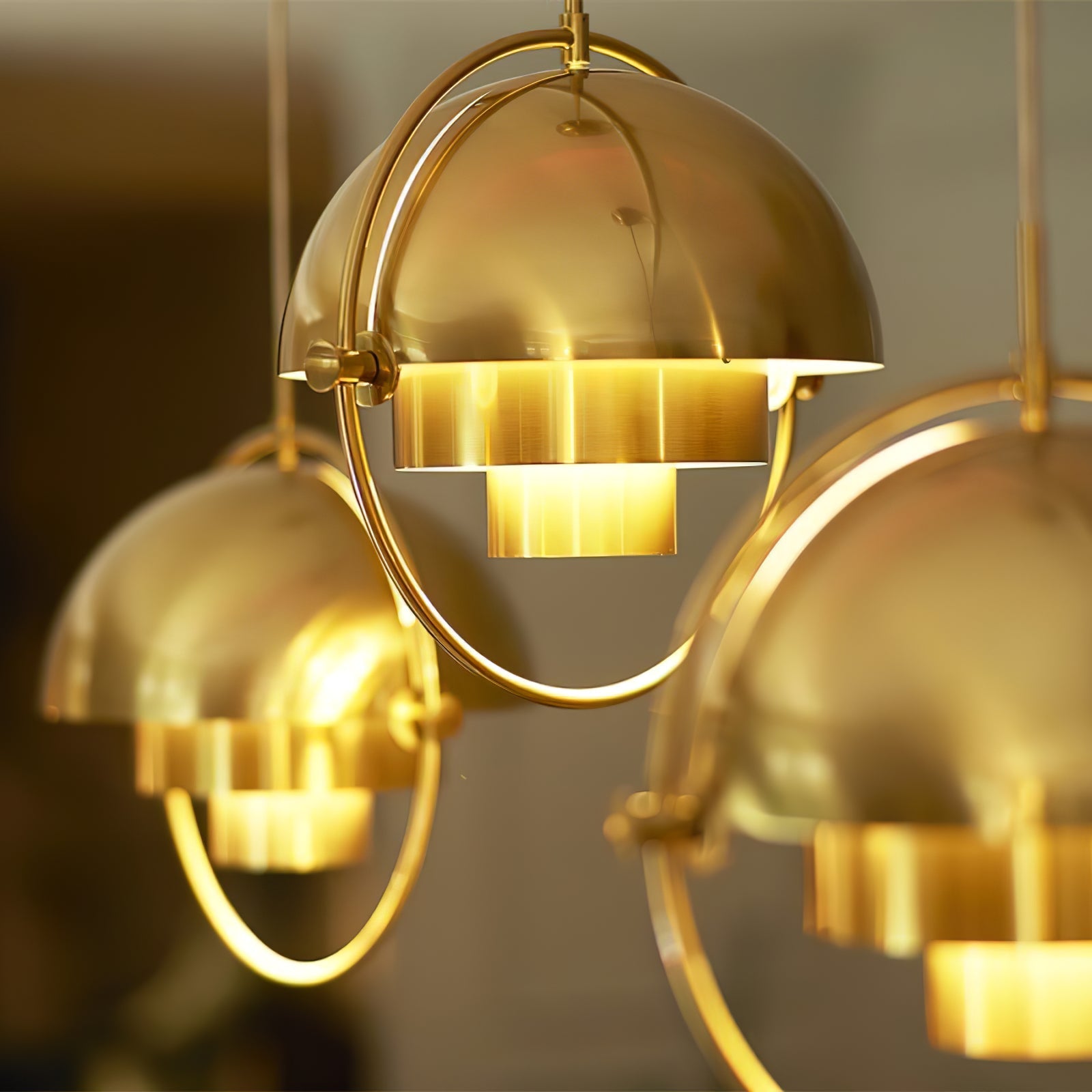 Multi-Lite pendant light with two movable hemisphere halves hanging in a styled interior