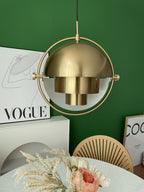 Multi-Lite pendant light in a copper finish suspended above a seating area