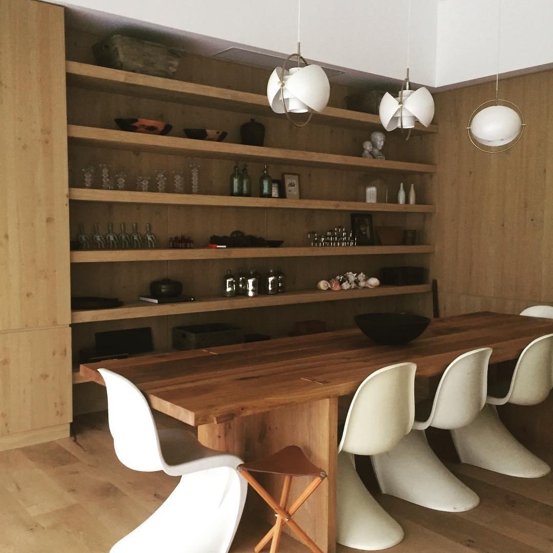 Multi-Lite pendant light over a dining table casting a focused downward pool of light