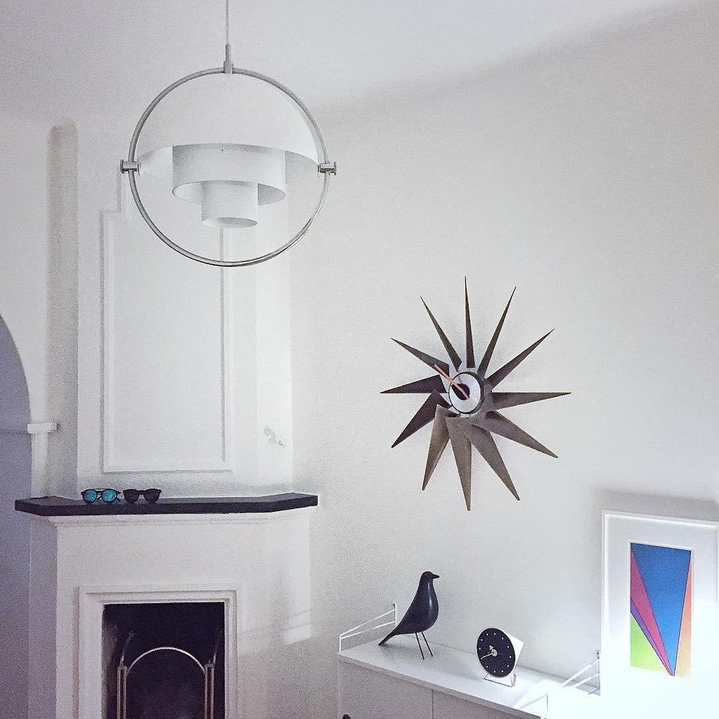 Multi-Lite pendant light in a copper finish suspended above a seating area