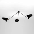 Against a soft grey backdrop, this Clérachic ceiling light's three black arms splay in a wide triangular spread.