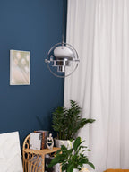 Multi-Lite pendant light with two movable hemisphere halves hanging in a styled interior