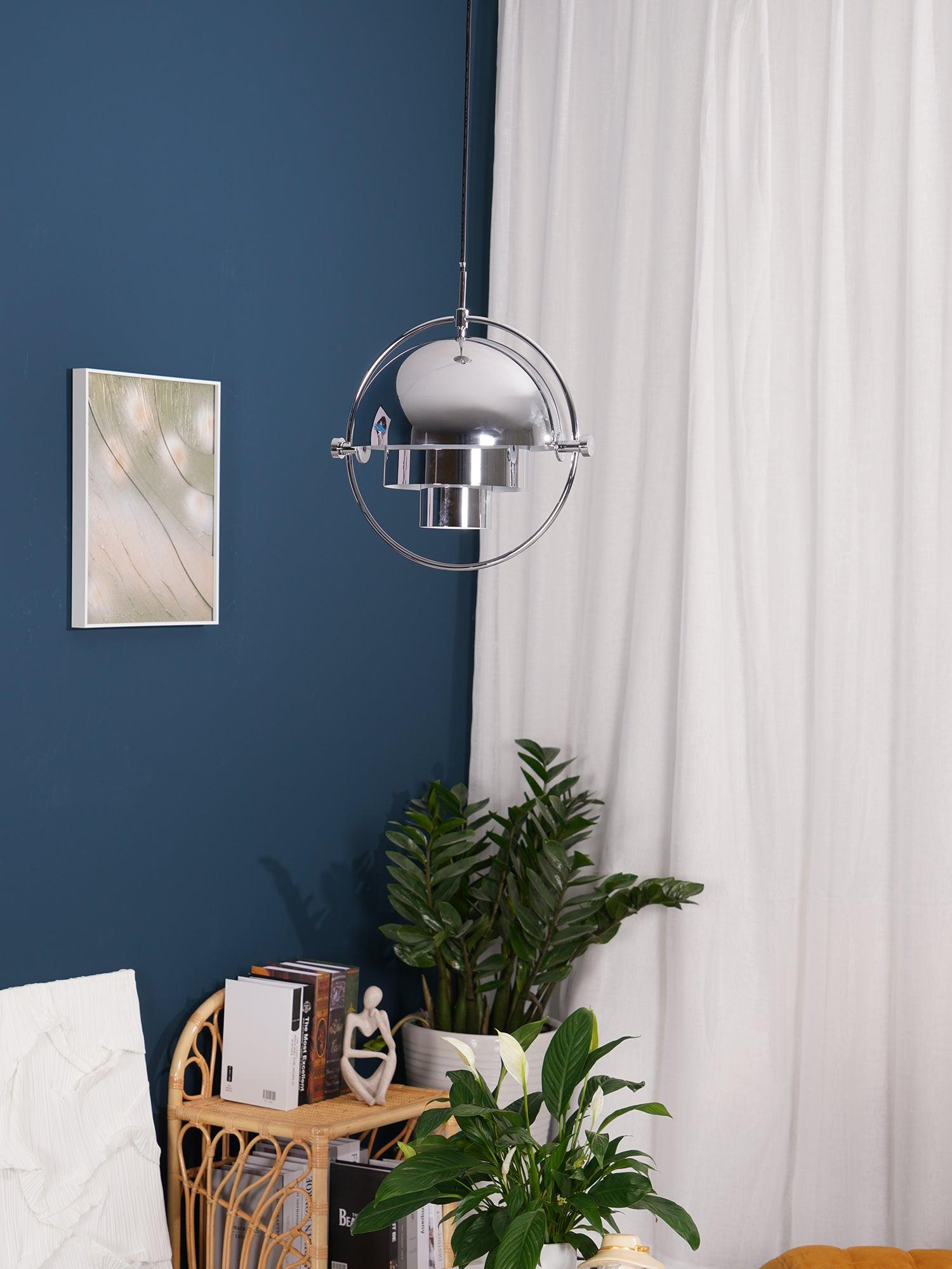 Multi-Lite pendant light with two movable hemisphere halves hanging in a styled interior