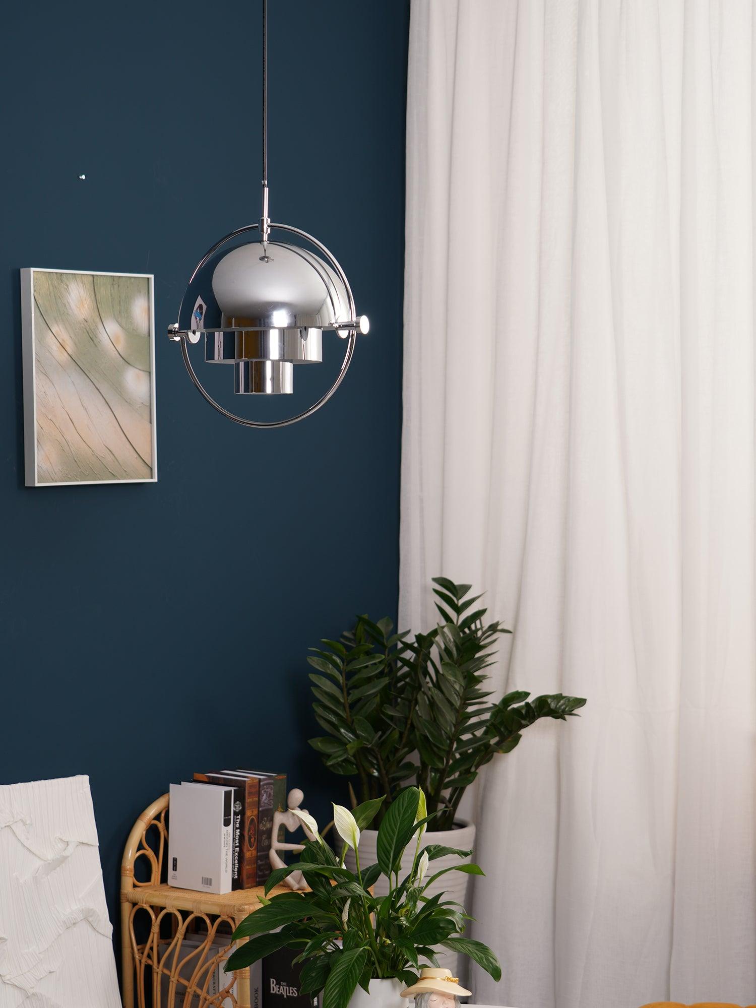 Multi-Lite pendant light with two movable hemisphere halves hanging in a styled interior