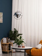 Multi-Lite pendant light over a dining table casting a focused downward pool of light