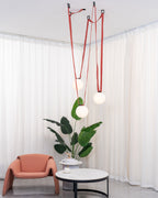 Multiple Belt Art Pendant Light hanging in a bright room