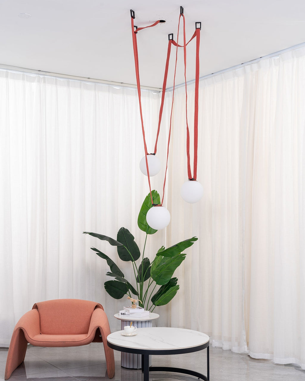 Multiple Belt Art Pendant Light globes lit in a warm interior