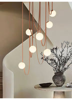 Multiple Belt Art Pendant Light styled above a table setting